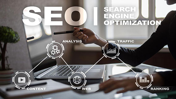 Close up of professional woman at a desk pointing a pen at her laptop screen with SEO diagram overlay.