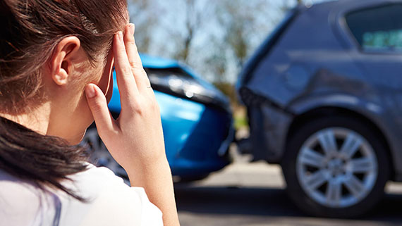 A snowmobiler following a well traveled path through hills