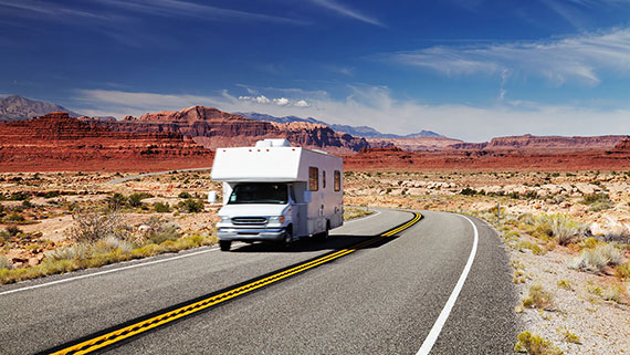 A motorhome traversing a scenic dessert landscape