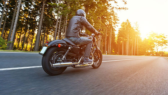 A motorcycle rider riding in the cool morning air